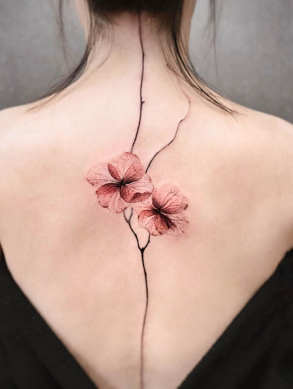 Oriental flower spine tattoo by @chenjie.newtattoo