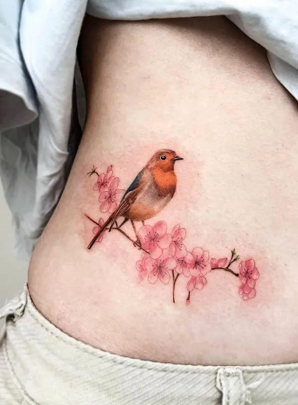 Robin and cherry blossom waist tattoo by @7thscapes