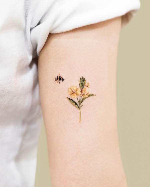 Small flower and bee tattoo by @tattoo.pencil