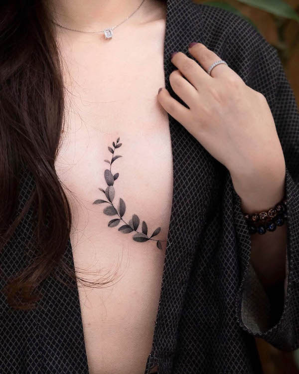 Small leaves boob tattoo by @newtattoo_qiqi