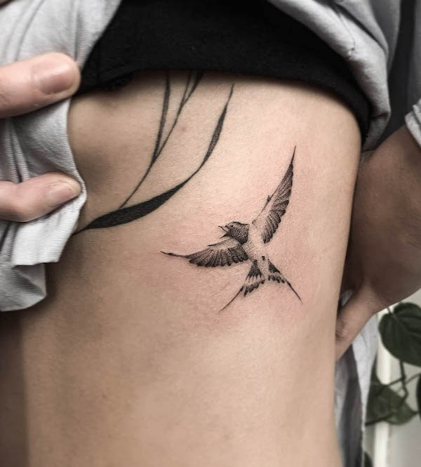 Black and white sparrow rib tattoo by @lucyctattoos