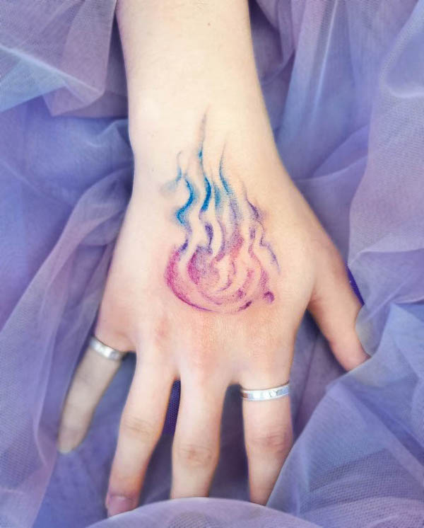 Watercolor fire hand tattoo by @nilah.tt_