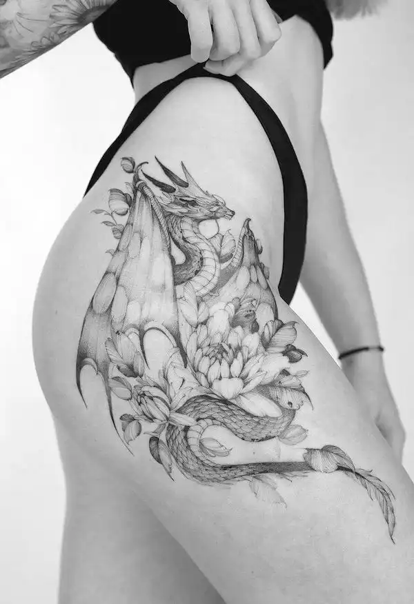 Fantasy dragon hip and thigh tattoo by @krapiva_tattoo