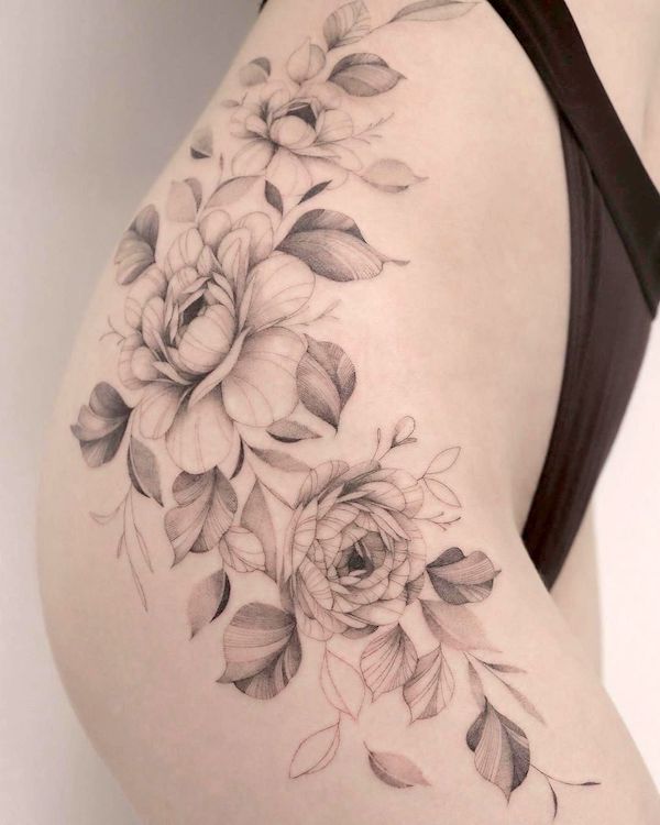 Ranuncolo e fiore di peonia tatuaggio dell'anca da @nzbd.tattoo