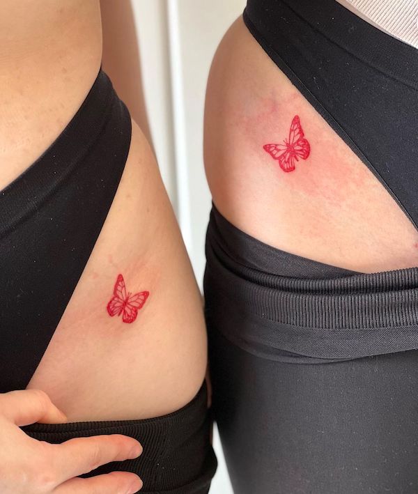 Red butterfly matching hip tattoos by @abidal_tattoo