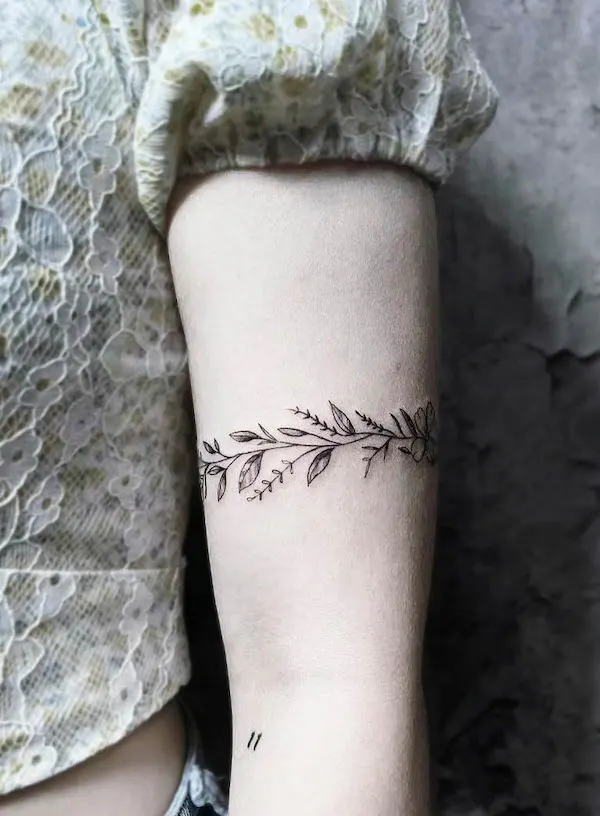 Simple leafy armband tattoo by @mostrotattoo.sg