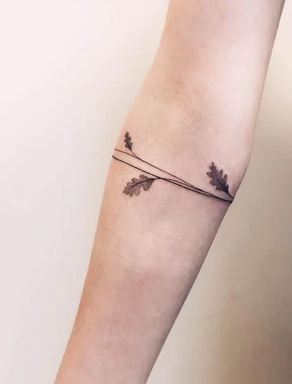 Simple straight line and leaves armband tattoo by @mon_o_tattoo