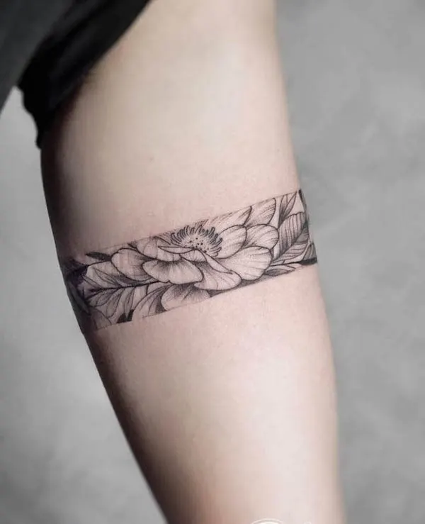 Sleek floral armband tattoo by @whiplashtattoo