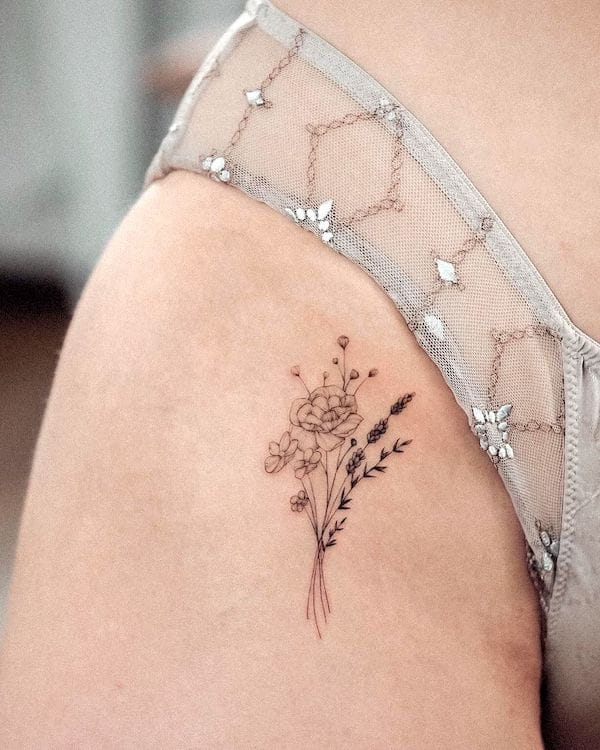 Small flower bouquet hip tattoo by @bunami.ink