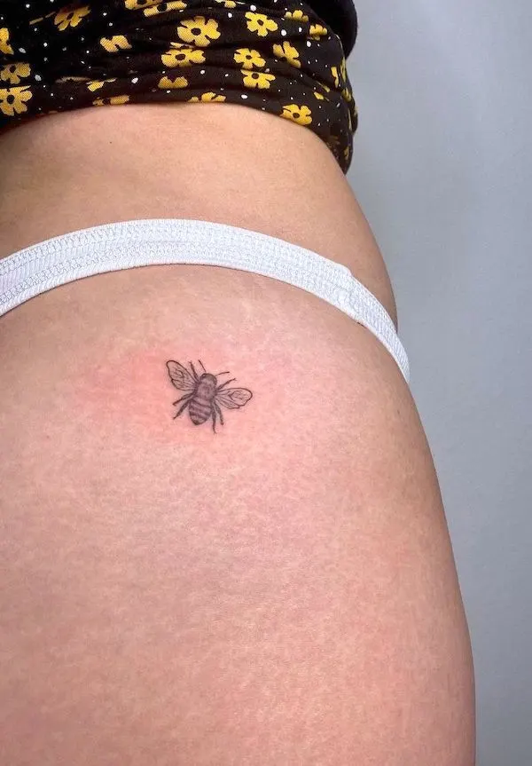 Tiny bee hip tattoo by @vvinkxo