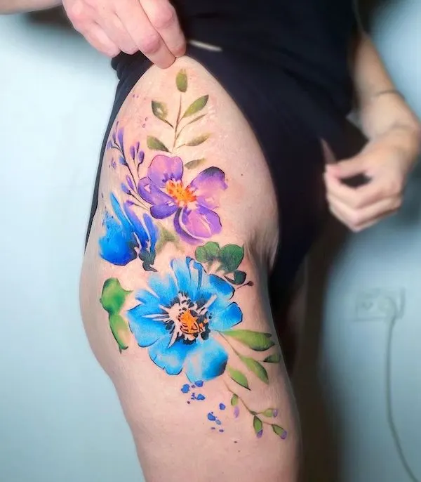 Watercolor flowers hip tattoo by @michal_y