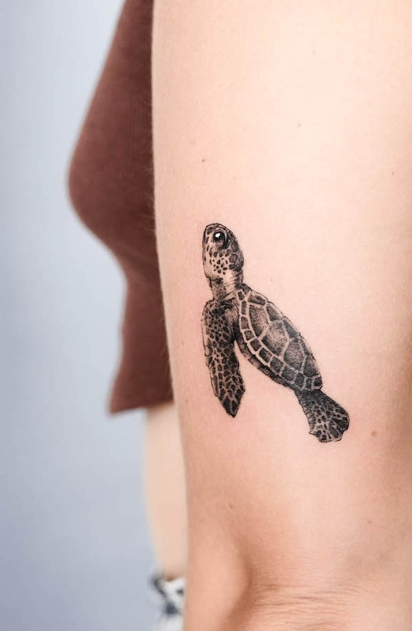 Detailed blackwork turtle arm tattoo by @louccia