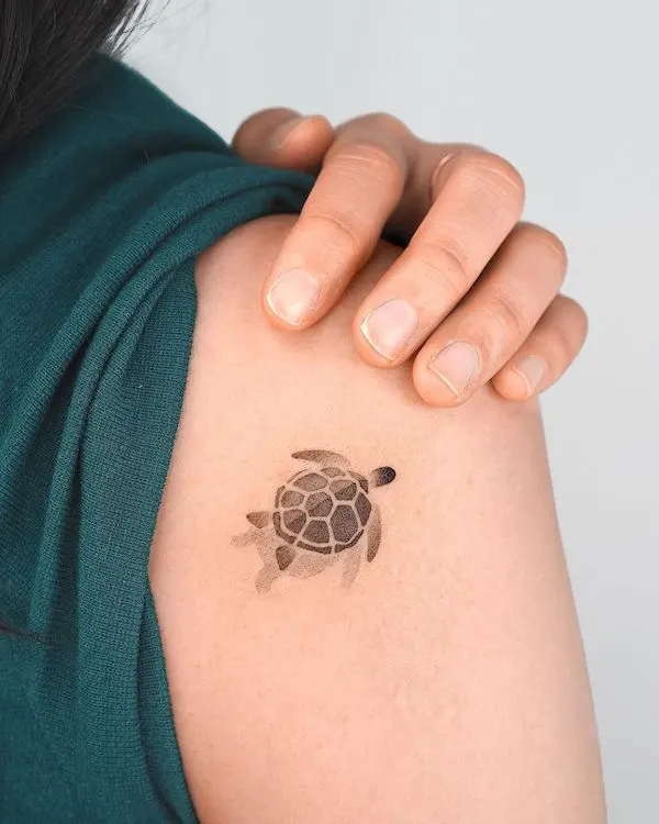 Tiny sea turtle shoulder tattoo by @choiyun_tattoo