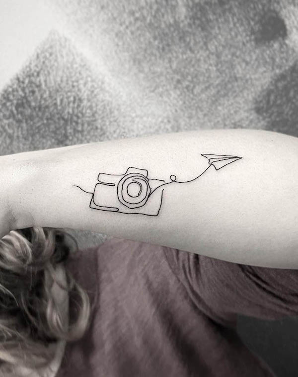 Minimalist camera tattoo on wrist