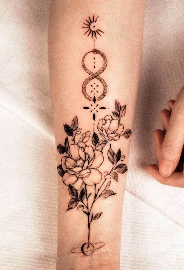 Symbols and flowers ouroboros tattoo by @hwan.ink