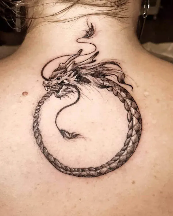 Flowy dragon ouroboros tattoo by @tali_lerner_tattoo