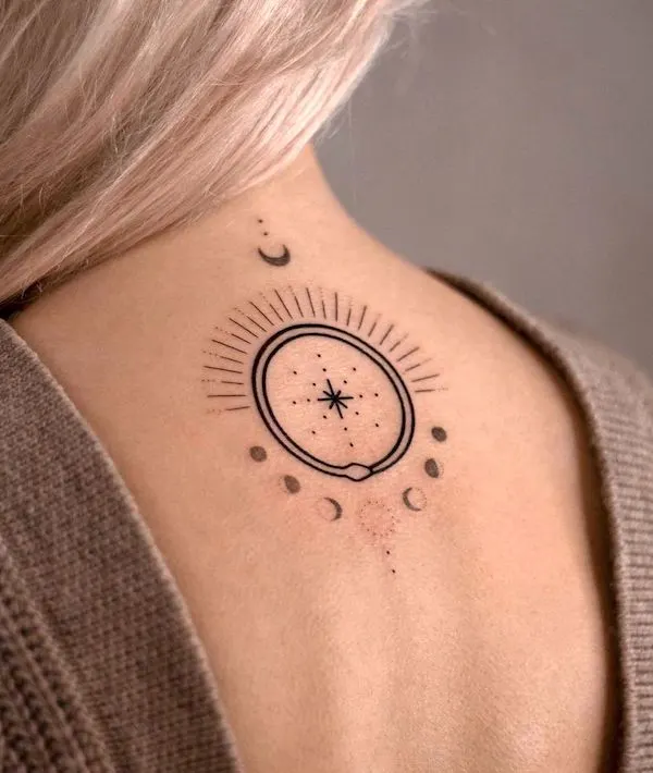 Simplified ouroboros with moon phase tattoo by @anylay.tattoo