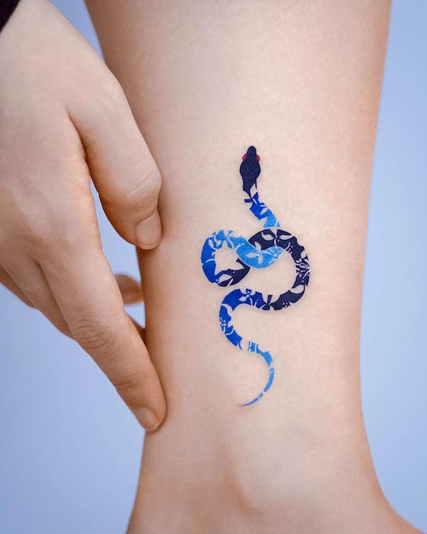 Blue snake ankle tattoo by @e.nal_.tattoo