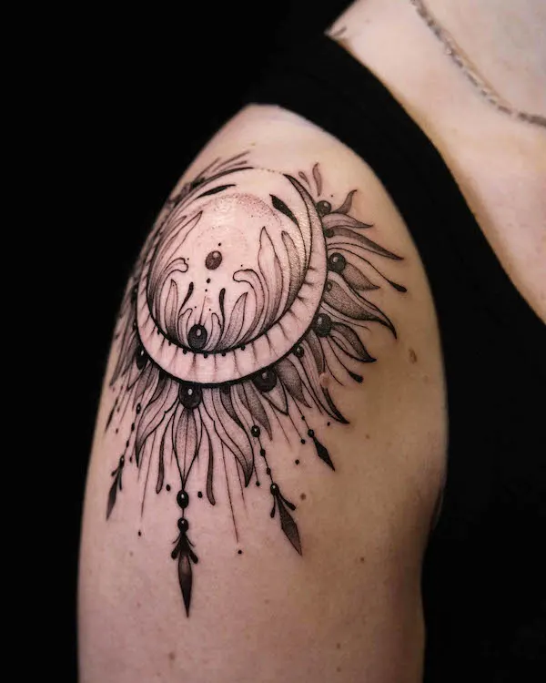 Bold black sun and moon shoulder tattoo by @dye_em_black