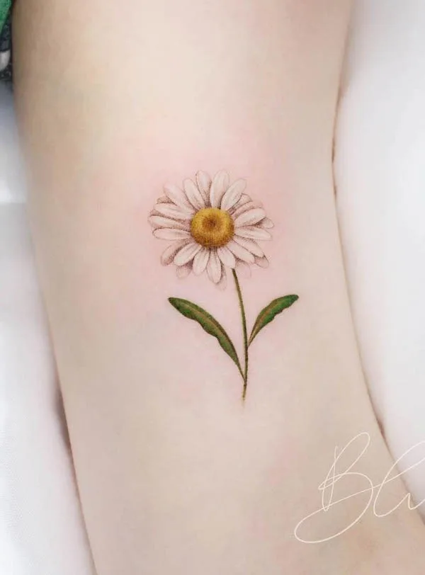Daisy April birth flower tattoo by @blu.tattoo