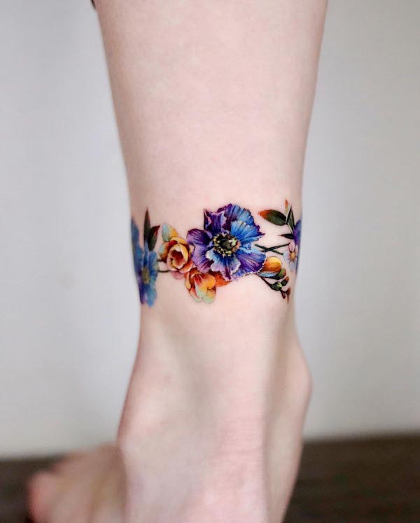Flowers wrap around the ankle tattoo by @non_lee_ink