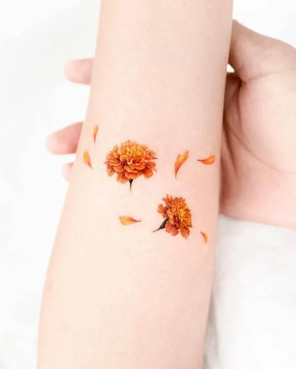 Marigold October birth flower tattoo by @donghwa_tattoo