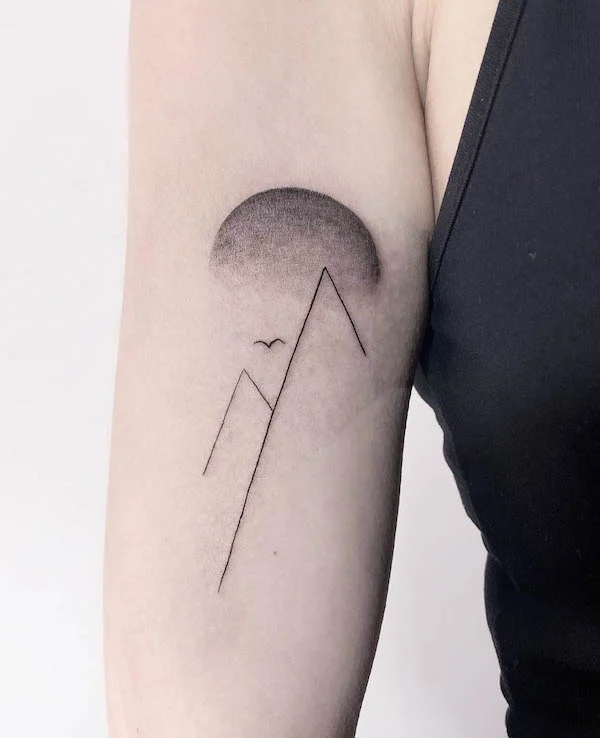 Simple mountains and sun tattoo by @justjoe_ink