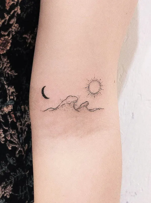 Minimalist hand poked sun and wave tattoo on the rib