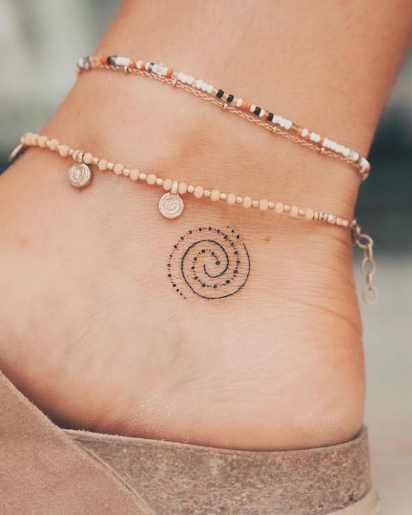 Tiny swirl ankle tattoo by @zmfreespirit
