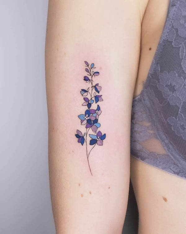 larkspur July birth flower tattoo by @muk.tatouage