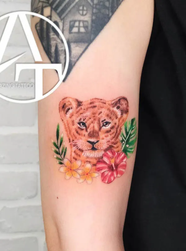 Grey shaded lion tattoo on inner forearm