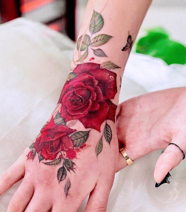 Beautiful red rose wrist and hand tattoo by @vandal_tattoo