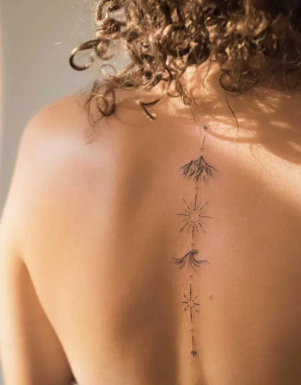 Beautiful symbols spine tattoo by @viktoria__tattooart