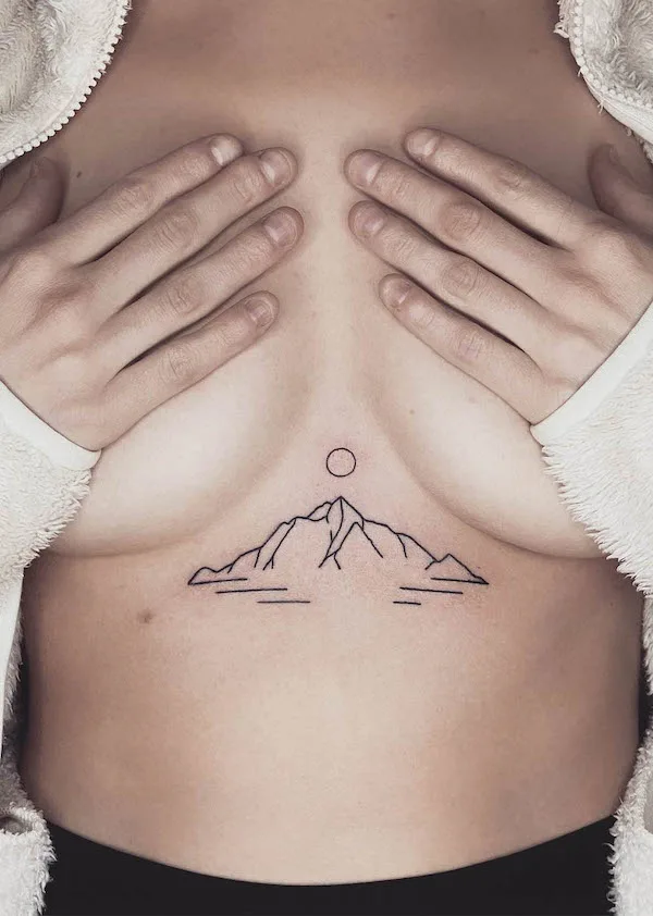 Between the boobs sunrise tattoo by @true_affection_pokes