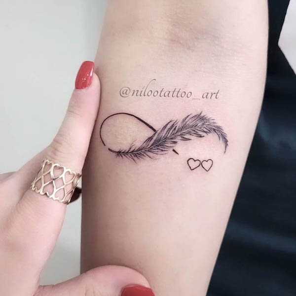Black and grey infinity feather tattoo by @nilootattoo_art