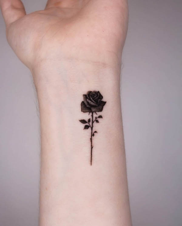 Black rose wrist tattoo by @smith__tattoo
