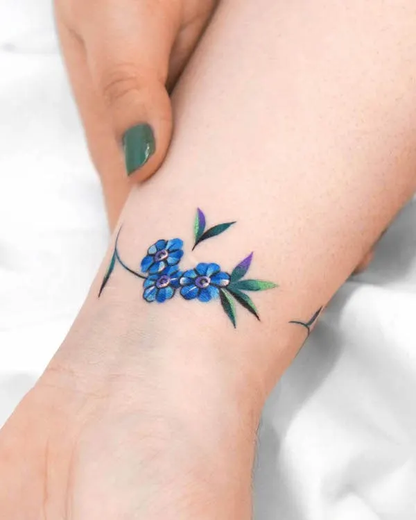 Blue floral bracelet tattoo by @eden_tattoo_
