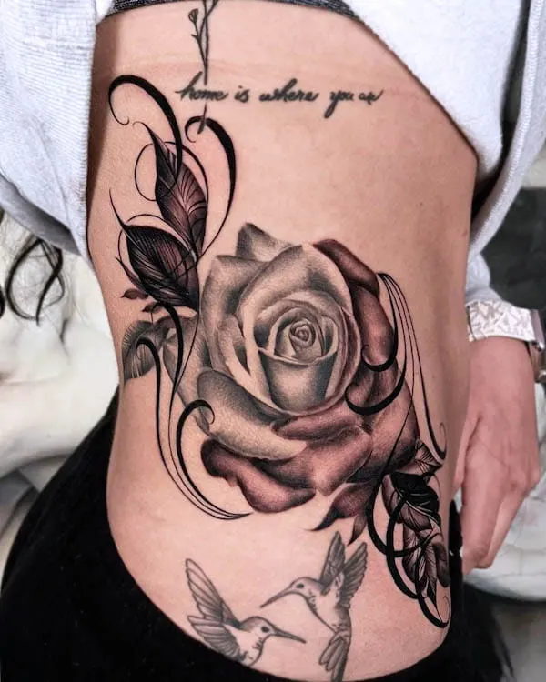 Blackwork style rose tattoo located on the thigh