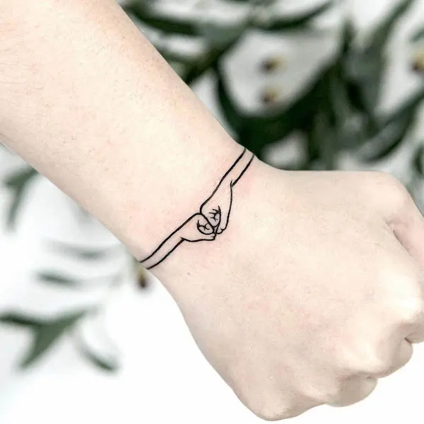Bro fist bracelet tattoo by @lana_here_tattoo