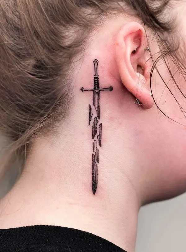 Broken sword behind the ear tattoo by @fun.tattooing