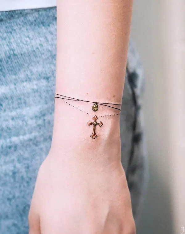 Cross bracelet tattoo by @olgacaca