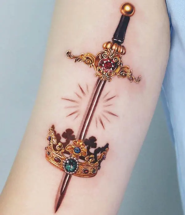 Crown and sword bicep tattoo by @jooa_tattoo