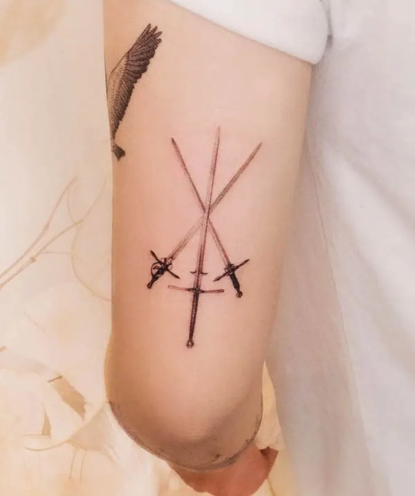 Dainty crossed sword tattoo by @hwahongtattoo