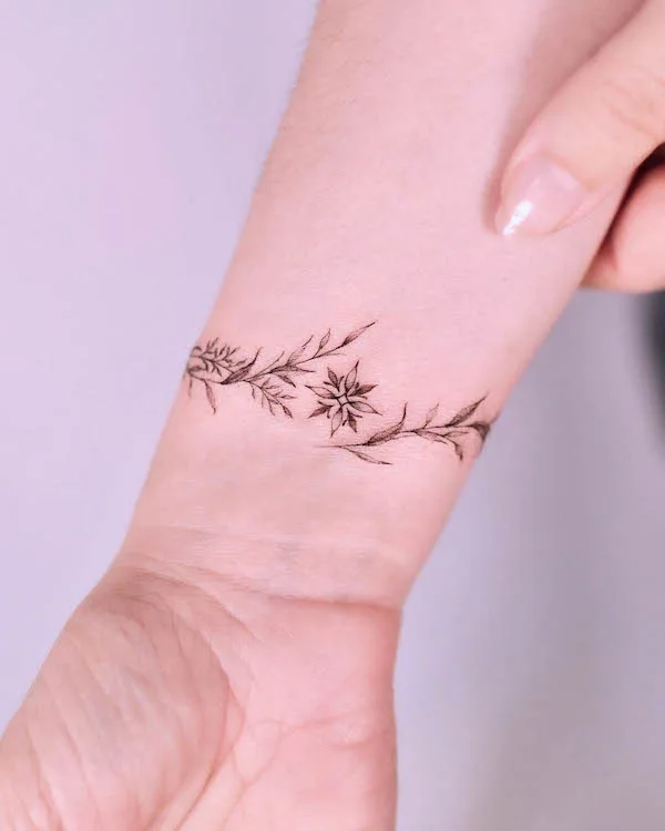 Dainty star and floral bracelet tattoo by @tattooist_gaon