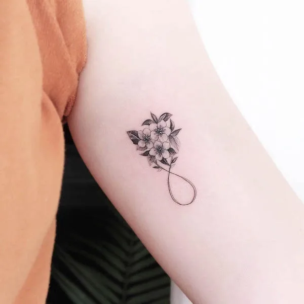 Elegant floral infinity tattoo by @tattooist_gree
