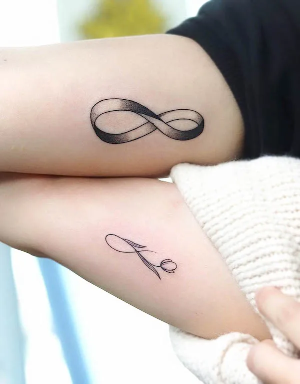 Matching infinity bicep tattoos by @tattooer_dogy