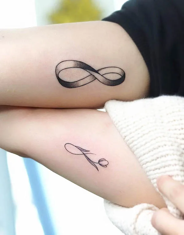 Minimalistic infinity symbol tattoo located on the hip.