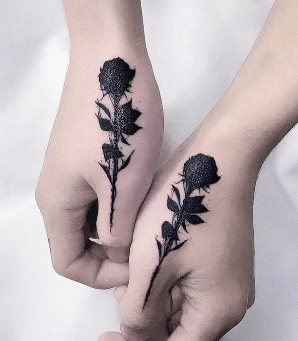 Matching rose thumb tattoos by @tattooist_hoji