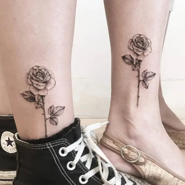 Matching rose ankle tattoos by @thetattoogarden