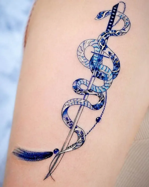 Porcelain snake and sword sleeve tattoo by @hwyl.tattoo